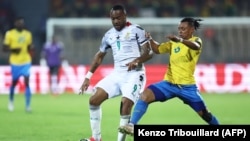 FILE: Ghana's forward Jordan Ayew (L) fights for the ball with Gabon's defender Johann Obiang during the Group C Africa Cup of Nations (CAN) 2021 football match between Gabon and Ghana at Stade Ahmadou Ahidjo in Yaounde. Taken 1.14.2022