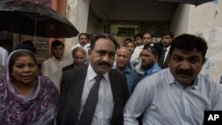 Tahir Naveed Chaudhry, center, lawyer of Christian girl accused of blasphemy, leaves after court hearing in Islamabad, Pakistan, September 3, 2012. 
