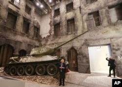 A woman stands in front of an exhibit in the Museum of the Second World War, an ambitious new museum under creation for nine years has opened its doors for a day to historians, museums and reporters in Gdansk, Poland, Jan. 23, 2017.