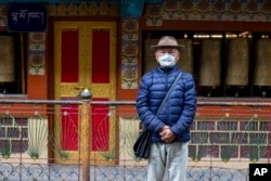 Kalsang Chokteng, an in exile Tibetan, poses for a photograph in Dharmsala, India, Tuesday, July 21, 2020. Kalsang says that people who do not want to wear masks are selfish and should think of the impact of their careless action on others.