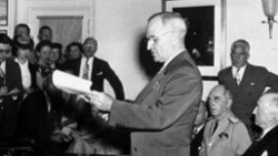 President Harry Truman announcing the Japanese surrender during a news conference at the White House