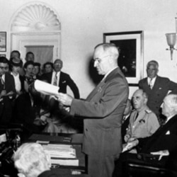 President Harry Truman announcing the Japanese surrender during a news conference at the White House