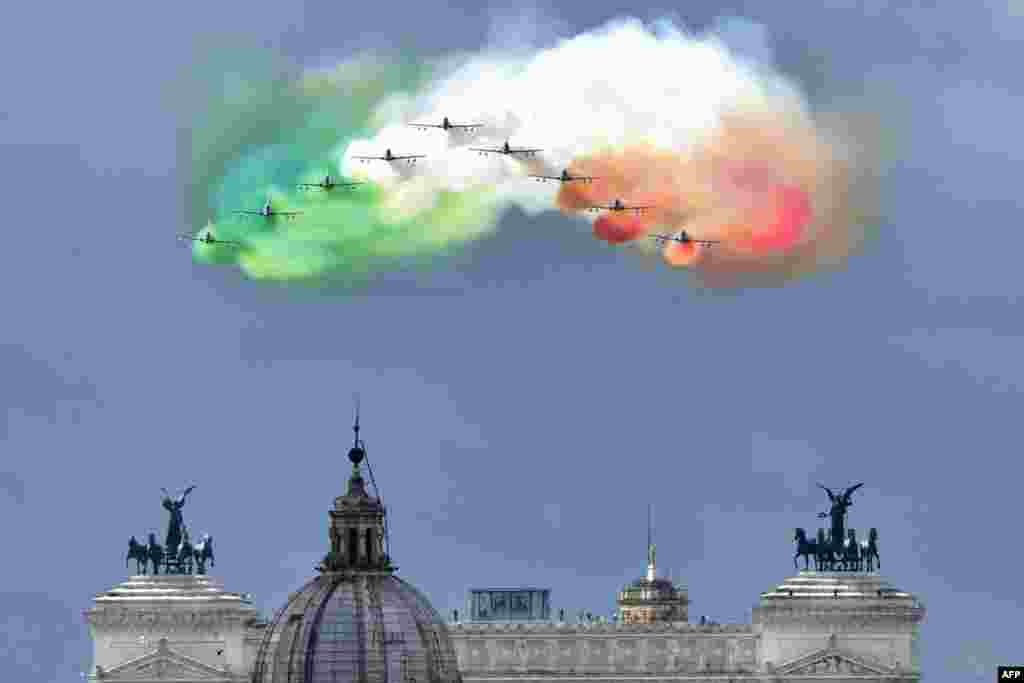 The Italian Air Force aerobatic unit Frecce Tricolori (Tricolor Arrows) spreads smoke with the colors of the Italian flag over the city of Rome as part of the Republic Day ceremony.