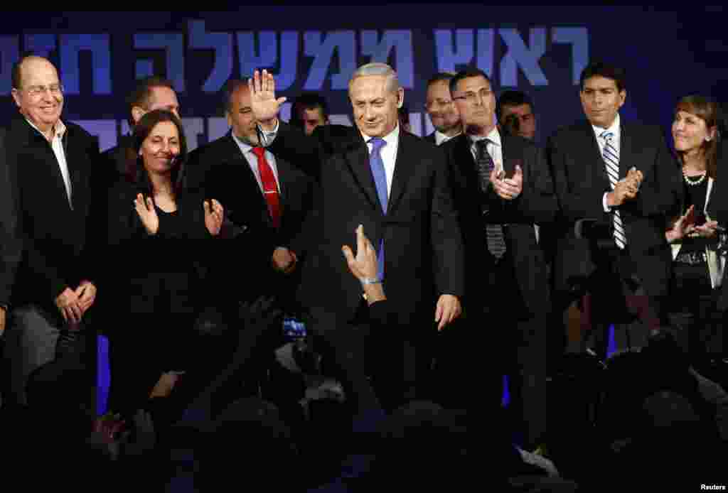 Israel's Prime Minister Benjamin Netanyahu waves to supporters as he stands at Likud party headquarters in Tel Aviv, January 23, 2013. 
