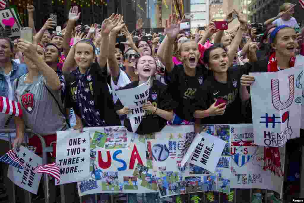 Fans of the U.S. women&#39;s soccer team cheer during the ticker-tape parade to celebrate their World Cup final win over Japan on Sunday, in New York, July 10, 2015.