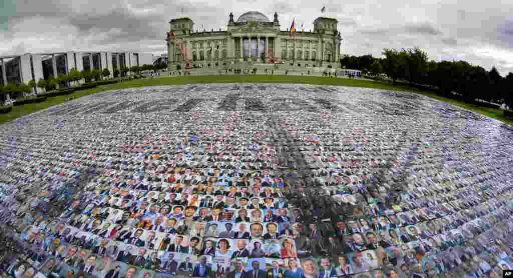 Portraits of politicans are placed in front of the Reichstag building, host of the German federal parliament Bundestag, by the &#39;#unverhandelbar&#39; (#non-negotiable) campaign group in Berlin, Germany, to protest against human rights at Europe&#39;s external borders.