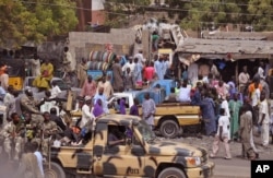 FILE - In this photo taken Jan. 27, 2015, Nigerian soldiers on a truck patrol at a market after recent violence in areas surrounding Maiduguri. In a major offensive against Boko Haram, Nigerian and Chadian jets are bombing the Islamic extremists.