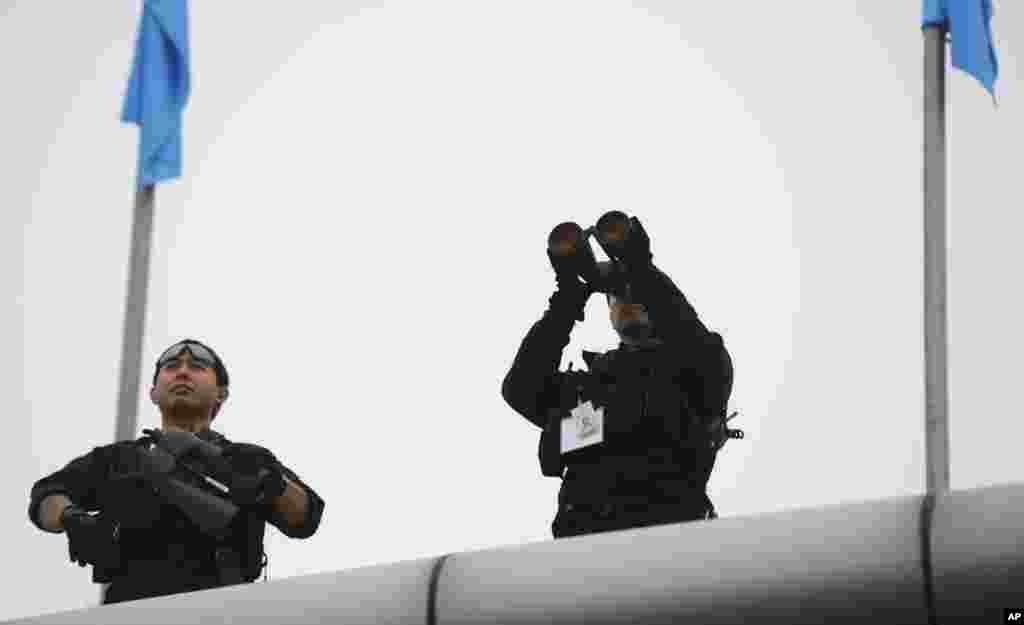 U.S. security officers keep vigil prior to the arrival of U.S. President Barack Obama at the Palam Air Force Station in New Delhi, India, Jan. 25, 2015.