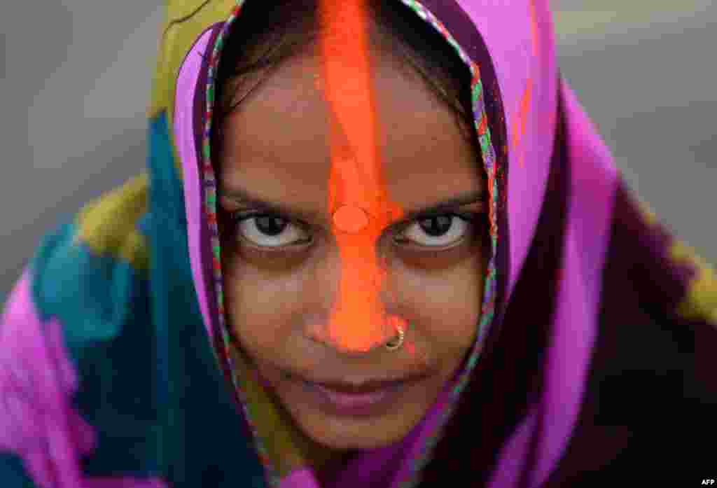 An Indian Hindu offers prayers a day before the Chhath festival on the Yamuna river in New Delhi. In this celebration of the sun god Surya, devotees fast by day and offer prayers as the sun sets over water.