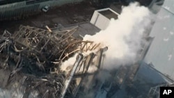 Smoke billows from wrecked unit 3 at Japan's crippled Fukushima Daiichi nuclear power plant in Okumamachi, Fukushima Prefecture, March 16, 2011