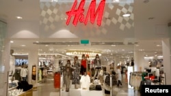 The company logo is placed at the flagship store of H&M, the world's second-biggest fashion retailer in Sweden's capital Stockholm, file photo. 
