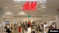 The company logo is placed at the flagship store of H&M, Hennes & Mauritz, HMb.ST, the world's second-biggest fashion retailer in Sweden's capital Stockholm, file photo.