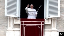 Pope Francis waves to the crowd as he arrives for the Angelus noon prayer from the window of his studio overlooking St.Peter's Square, at the Vatican, Feb. 25, 2018. 