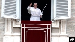 FILE - Pope Francis waves to the crowd as he arrives for the Angelus noon prayer from the window of his studio overlooking St. Peter's Square, at the Vatican, Feb. 25, 2018. 