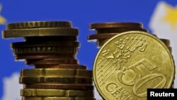 Euro coins are seen in front of displayed flag and map of European Union in this picture illustration taken in Zenica, Bosnia and Herzegovina, May 28 2015.