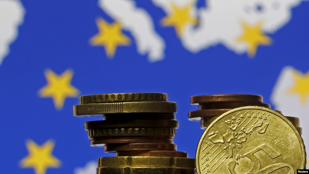 Euro coins are seen in front of displayed flag and map of European Union in this picture illustration taken in Zenica, Bosnia and Herzegovina, May 28 2015.