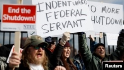 Union members and Internal Revenue Service workers rally outside an IRS Service Center to call for an end to the partial government shutdown, Jan. 10, 2019, in Covington, Ky. 