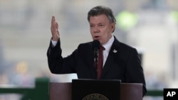 FILE - In this photo taken Nov. 6, 2015, Colombia's President Juan Manuel Santos speaks at the rebuilt Palace of Justice in Bogota, Colombia. 