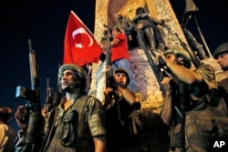 FILE - Turkish soldiers secure the area as supporters of Turkey's President Recep Tayyip Erdogan protest in Istanbul's Taksim square, early Saturday, July 16, 2016.