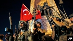 FILE - Turkish soldiers secure the area as supporters of Turkey's President Recep Tayyip Erdogan protest in Istanbul's Taksim Square during an attempted coup, July 16, 2016.