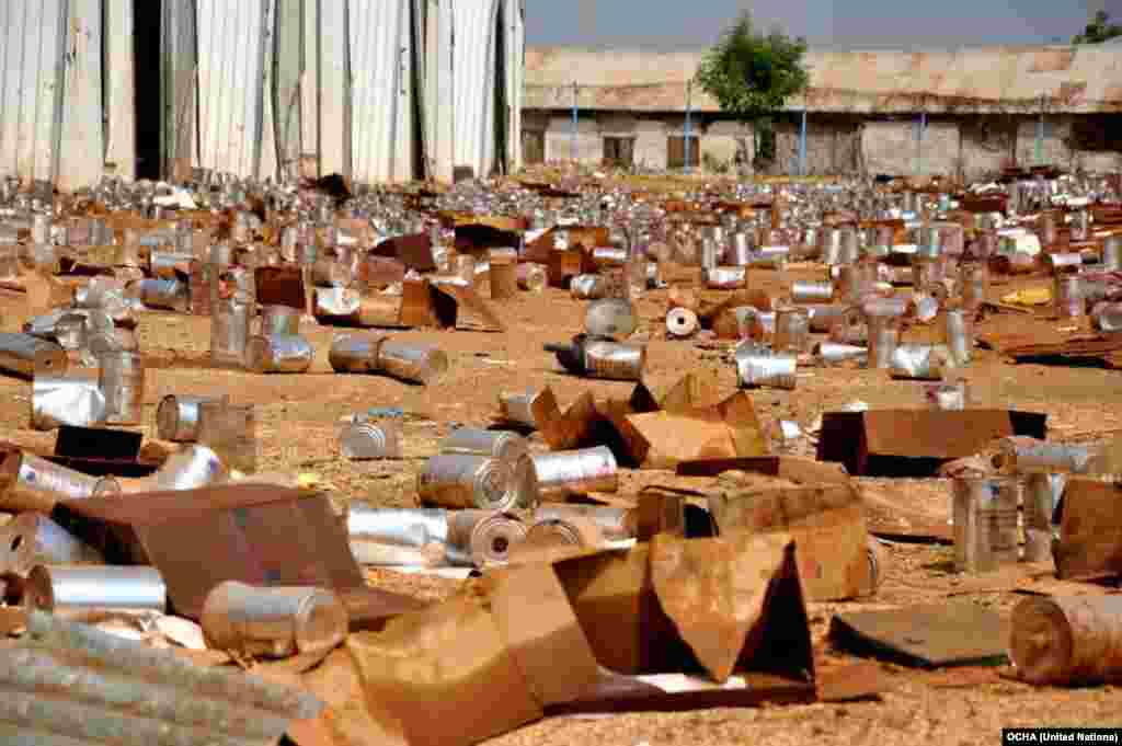 Empty tins litter the ground at the looted compound of an aid agency in Malakal, South Sudan.
