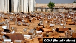 Empty tins litter the ground at the looted compound of an aid agency in Malakal, South Sudan.