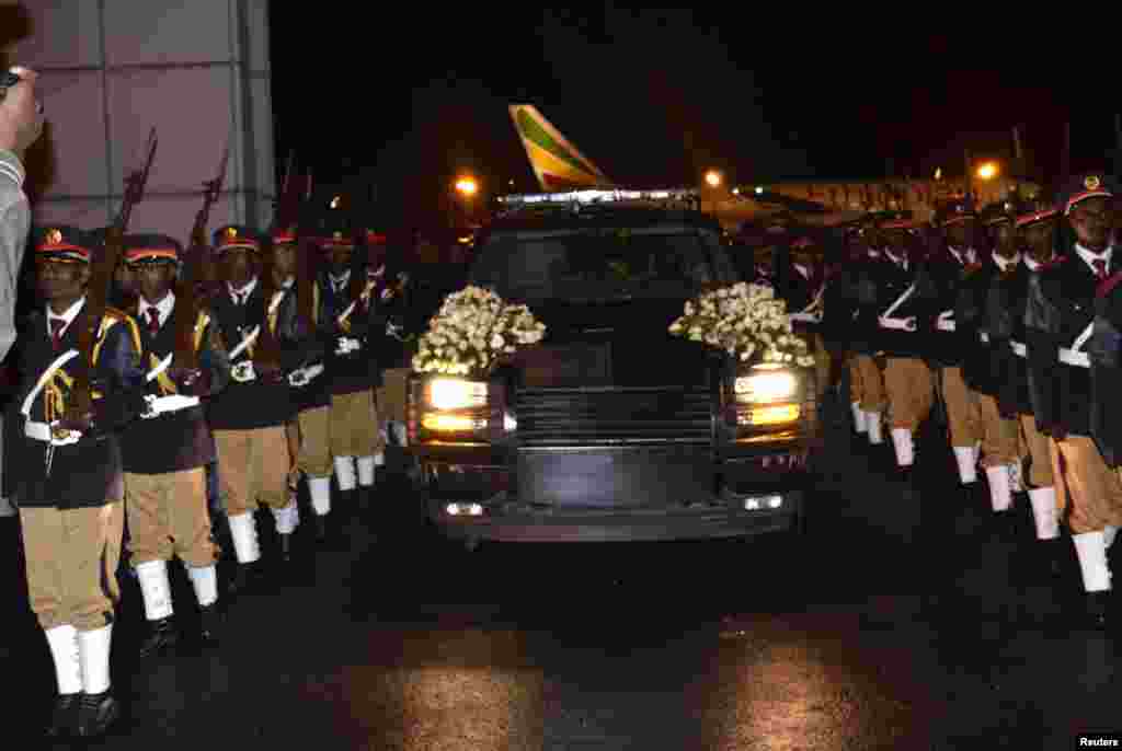 The body of Ethiopia's Prime Minister Meles Zenawi is escorted upon arrival in Ethiopia's capital Addis Ababa early August 22, 2012.