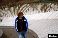 Marco Smit, a former member of the Dutch battalion serving with the U.N. peacekeepers, walks near a memorial plaque in the memorial center near the former U.N. safe base in Potocari, near Srebrenica, Bosnia and Herzegovina, Feb. 9, 2017.