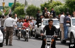 FILE - Reformist Iranian presidential candidate, Mahdi Karroubi, with white turban at right, arrives in Doroud during his campaign tour to his home region in the Lorestan province about 190 miles (315 kilometers) southwest of Tehran, Iran, May 27 2009.