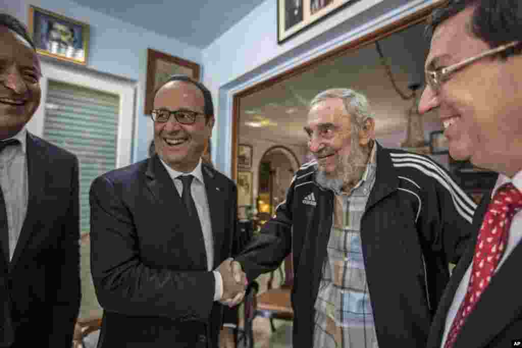 Cuba&#39;s former leader Fidel Castro shakes hands with French President Francois Hollande, while accompanied by Cuba&#39;s Foreign Minister Bruno Rodriguez (right) in Havana, Cuba, May 11, 2015.