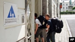 FILE - Backpackers enter a hostel in Brussels, Belgium, July 31, 2008.