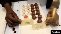 A sales worker arranges chocolate products inside the Absolute Chocolate shop in Kenya's capital, Nairobi, March 20, 2015. 
