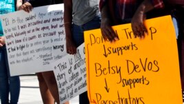 People gather to protest proposed changes to Title IX before a speech by Education Secretary Betsy DeVos, Thursday, Sept. 7, 2017, at George Mason University Arlington, Va.