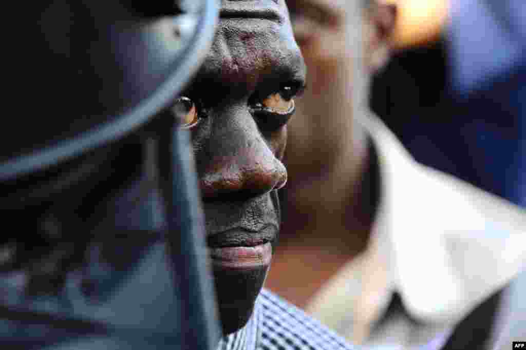 April 14: Uganda's Forum for Democratic Change leader Kizza Besigye is arrested by anti-riot policemen at the Kasangati suburb of the capital Kampala. (Reuters)