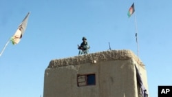 FILE - An Afghan soldier guards at a checkpoint in the Nad Ali district of Helmand province, Afghanistan, Dec. 22, 2015.