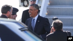 President Barack Obama greets Nevada Gov. Brian Sandoval upon his arrival on Air Force One at McCarran International Airport Monday, Aug. 24, 2015, in Las Vegas.