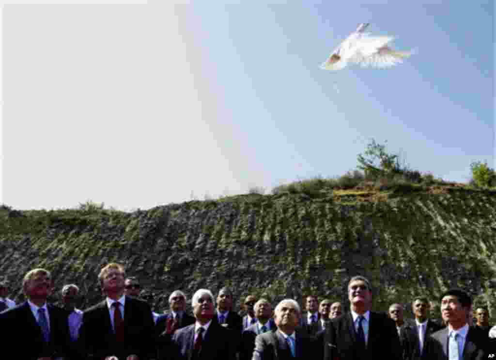 President Dimitris Christofias, third right, and Turkish Cypriot Dervis Eroglu, third left, release two doves symbolizing peaceful coexistence between the two communities, as Stefan Fule, second left, member of the European Commission responsible for Enla
