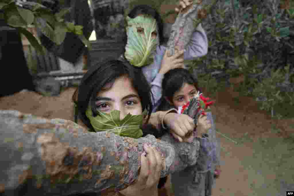 Palestinian children pose with masks made of cabbage in Beit Lahia in the northern Gaza Strip amid the coronavirus pandemic.