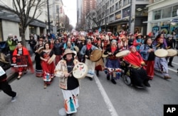 Native American drummers sing as they help lead the Women's March in Seattle, Jan. 19, 2019.