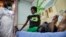 A newly-diagnosed HIV positive woman, who arrived at the hospital with symptoms of tuberculosis (TB), receives treatment at the Mildmay Uganda clinic, which receives funding from the US government through the Centers for Disease Control and Prevention (CD
