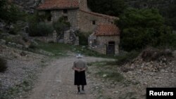 FILSinforosa Sancho, 84, takes a walk in the empty village of La Estrella, Spain, May 24, 2018. For more than 30 years, Sinforosa and her husband Juan Martin Colomer had lived alone in the village that once had more than 200 inhabitants.…