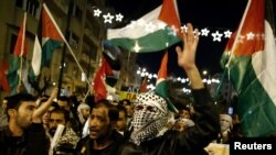 People take part in a protest against Donald Trump's decision to recognize Jerusalem as the capital of Israel, in Athens, Greece, Dec. 8, 2017.