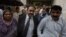 Tahir Naveed Chaudhry, center, lawyer of Christian girl accused of blasphemy, leaves after court hearing in Islamabad, Pakistan, Sept. 3, 2012. 