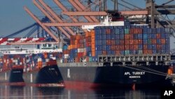 FILE - Container ships are seen docked at the Port of Los Angeles, Feb. 23, 2015.