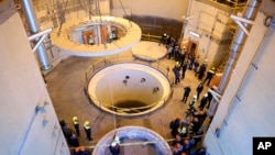 FILE - In this photo released by the Atomic Energy Organization of Iran, technicians work at the Arak heavy water reactor's secondary circuit as officials and media visit the site, near Arak., Dec. 23, 2019.