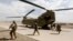 FILE - U.S. troops walk from a Chinook helicopter in Uruzgan province, Afghanistan, July 7, 2017. 