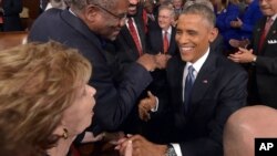 President Barack Obama greets lawmakers ahead of his State of the Union address to a joint session of Congress on Capitol Hill, Jan. 20, 2015, in Washington.