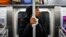 FILE - A subway passenger used a tissue to protect her hand from a pole as COVID-19 concerns drove down ridership in New York, March 19, 2020, Pandemic concerns have eased since then, but the return to "normal" is causing anxiety for some people. 