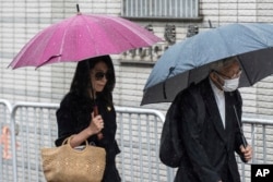 Jimmy Lai's wife, Teresa Lai, and retired Chinese Cardinal Joseph Zen Ze-Kiun arrive at West Kowloon Magistrates' Courts to attend Hong Kong activist publisher Lai's national security trial in Hong Kong, Nov. 20, 2024.