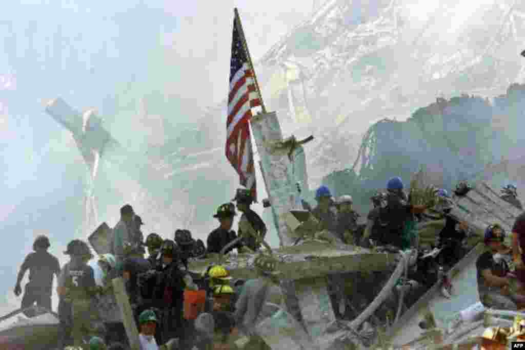 An American flag is posted in the rubble of the World Trade Centers Thursday, Sept. 13, 2001, in New York. The search for survivors and the recovery of the victims continues since Tuesday's terrorist attack. (AP Photo/Beth A. Keiser)